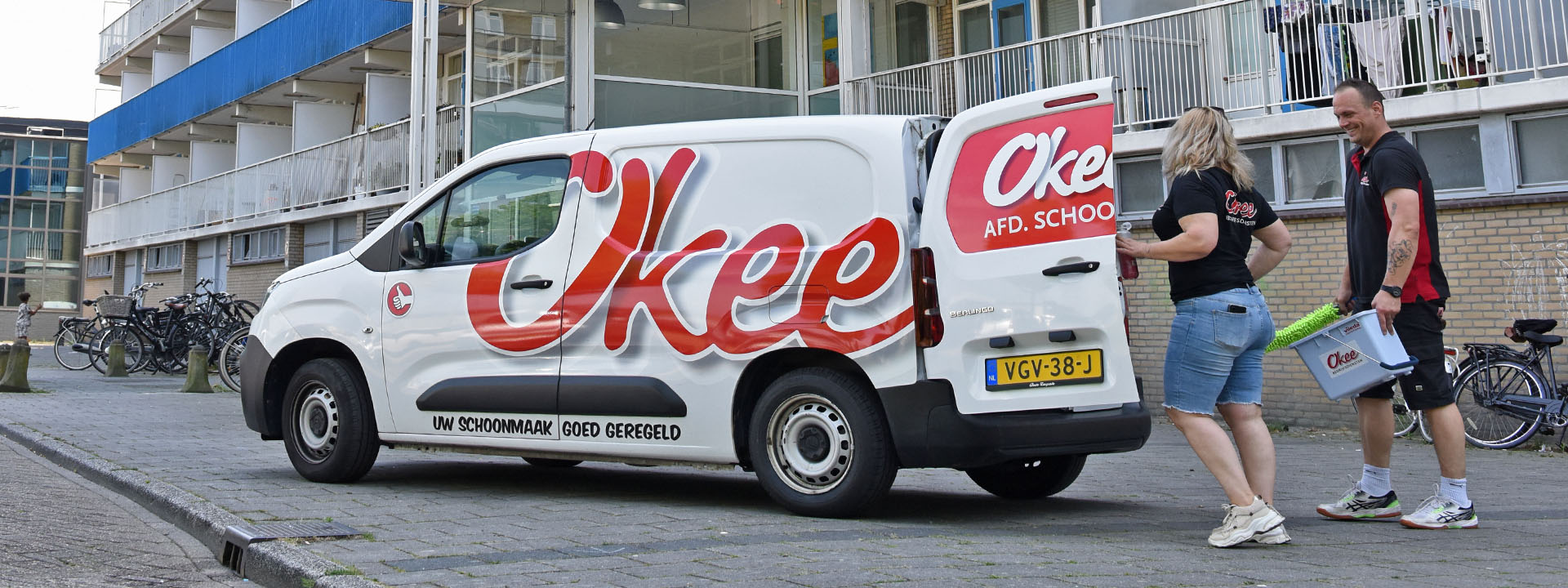 Okee-bedrijfsauto met schoonmaakmedewerkers – auto van de zaak
